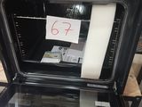 a black oven with a note taped to it ' s door
