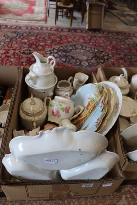 a box full of tea cups and saucers on the floor
