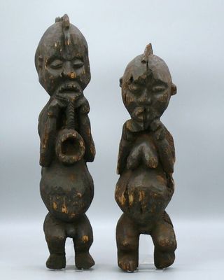 pair of african carved wood figurines of a man and a woman