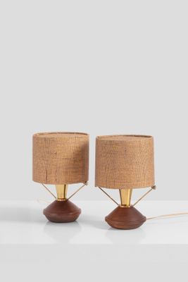 a pair of lamps on a white table with a brown shade
