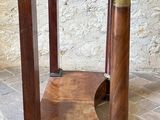 a small wooden table with a marble top on a tiled floor