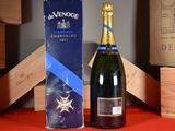 a bottle of champagne sitting next to a box of wine