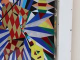 brightly colored abstract painting on a white wall in a room