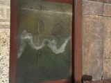 a picture of an old wooden box hanging on a wall