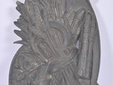 a metal sculpture of a woman with a bird on her head
