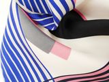 a close up of a blue and white scarf with pink stripes