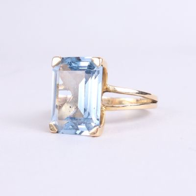 an image of a ring with a blue topazt stone