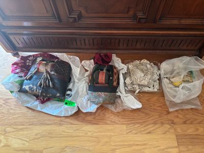 several bags of food are hanging on a wall in a kitchen