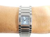 a silver wrist watch on a person ' s wrist