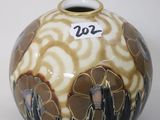 a vase with a design on it sitting on a table