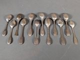 six silver spoons are arranged in a row on a table