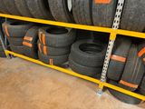 a lot of tires on a shelf in a store