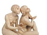 a statue of a man and a woman sitting on the ground