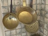 pots and pans hanging on a wall in a bathroom