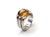 a close up of a ring with a citrine stone on it