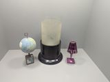 a blender sitting on a table next to a globe and a lamp