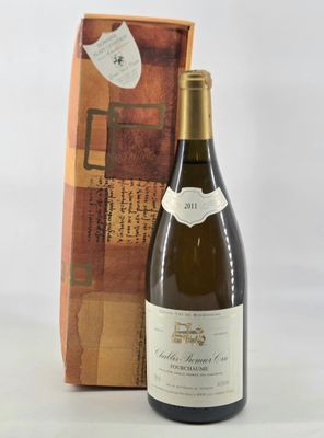 the bottle of wine is sitting next to a box of wine