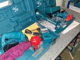 a blue tool box with tools in it sitting on a table