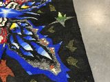 a rug with a butterfly design on it on the floor