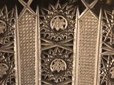 a close up of a silver plate with intricate designs on it