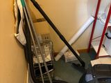 an image of a room that has a vacuum and other items on the floor