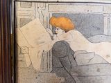 a picture of a woman reading a book on the couch