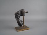 an image of a statue of a hand holding a hammer