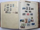 an open book with stamps on it on a table