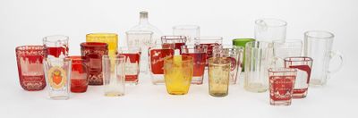 a lot of different colored glass vases on a white surface