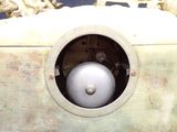 a clock that is sitting in the middle of a pile of skulls