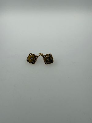 a pair of earrings on a white surface