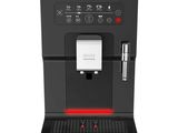 a black coffee machine with a red light on it