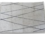 a close up of a white rug with black lines on it