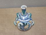 a blue and white vase sitting on a table