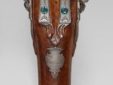 a vase that has a bunch of silver cups on top of it