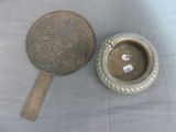 a silver plate with a mirror on it next to a mirror