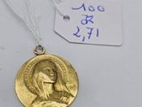 a gold medal with the image of jesus on it