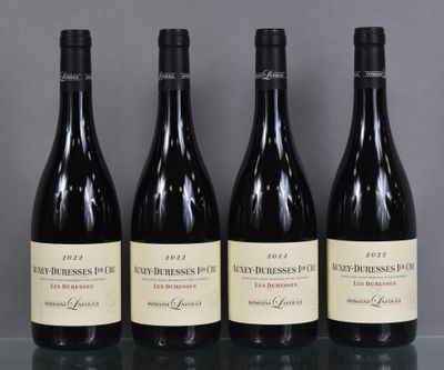 three bottles of wine are lined up on a glass table