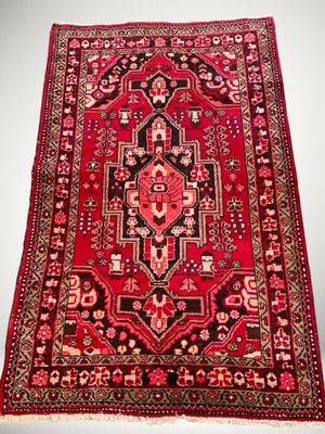 un tapis rouge orné d'un motif élaboré sur fond blanc