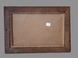 an old wooden picture frame with a sticker on it