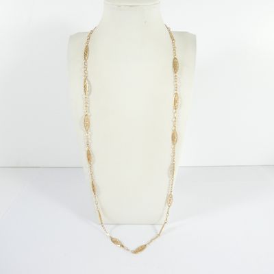 a white mannequin with a gold chain and a long necklace