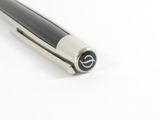 a pen that is laying on a white surface