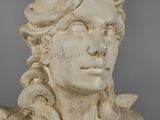 marble bust of a woman with braids and a hat