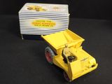 a yellow toy truck that is next to a box of cards