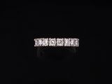 a diamond five stone ring on a black background