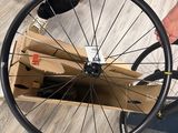 a man that is holding a bike wheel in his hand