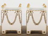 two white and gold vases sitting on top of a table