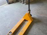a forklift sitting in the middle of a warehouse floor
