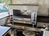 an image of a kitchen area with a stove and a grill