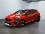 Une voiture rouge est garée dans une pièce aux murs blancs.